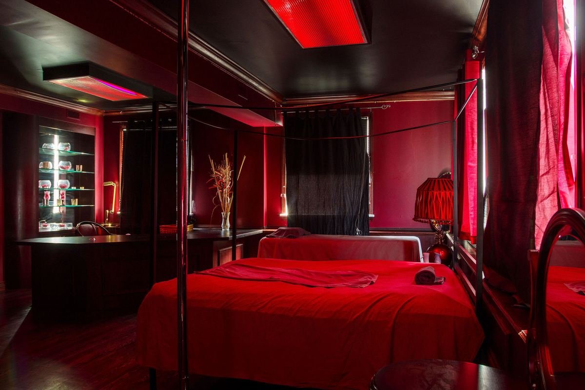 A red-lit private room at Luxe Downtown East massage club
